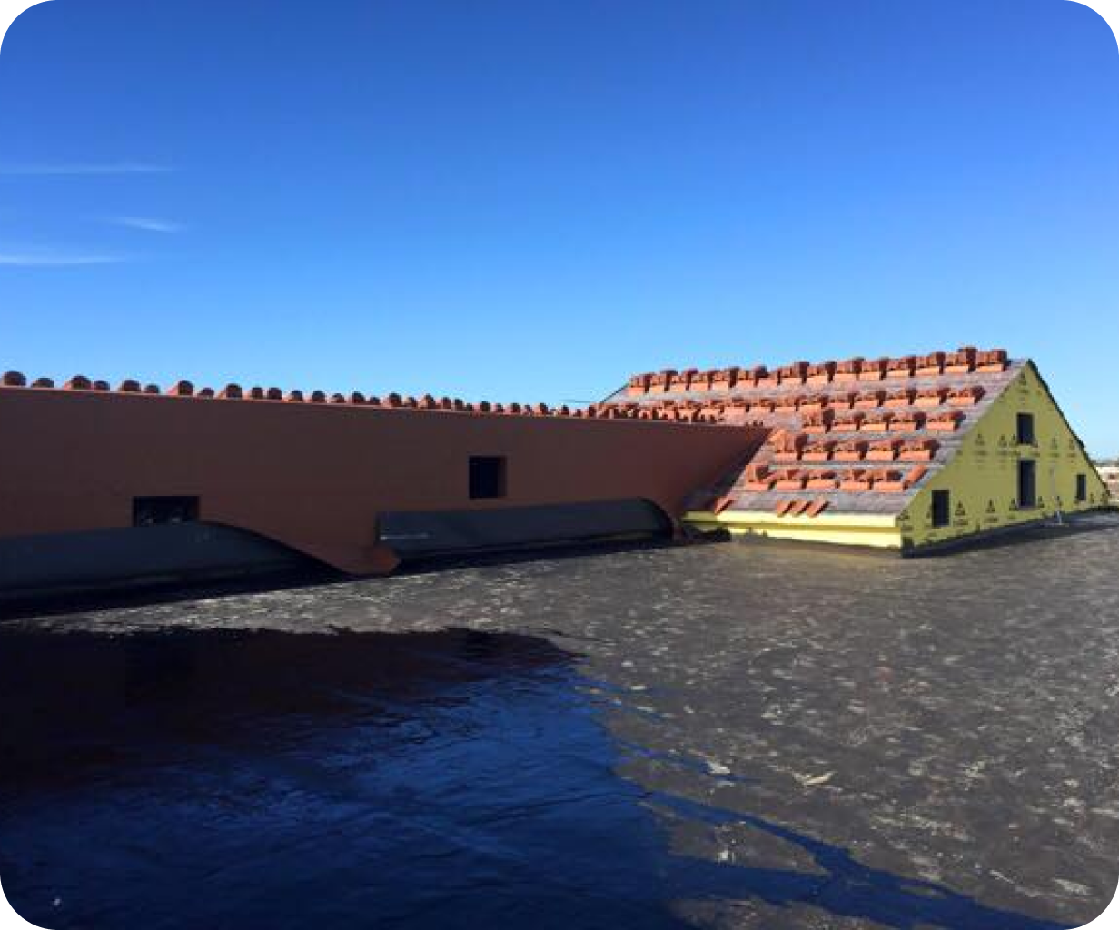 Commercial roof under construction with tile roof